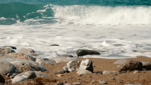 Sea Waves Are Crashing on Stones and Spraying in Slow Motion. Beautiful Beach in Crimea with Stones