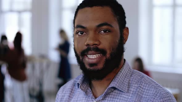 Close-up Portrait of Happy Smiling Bearded Black CEO Businessman Posing at Modern Trendy Office