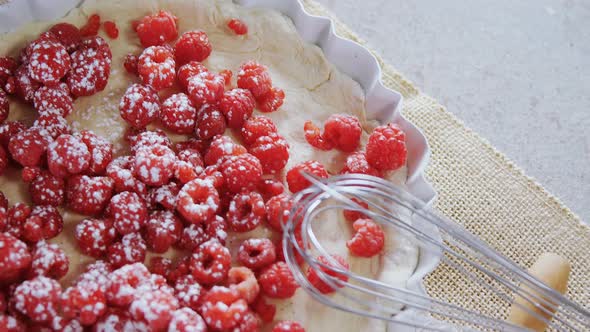 Red berries on tart with whisker and rolling pin 4k