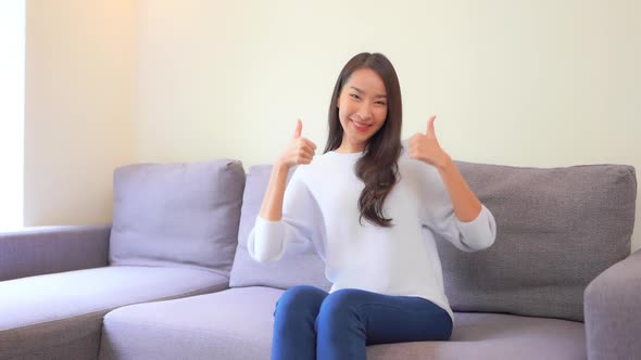 Asian woman sit on sofa and relax