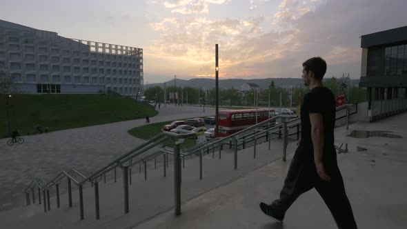 Man going down stairs outside Cluj Arena