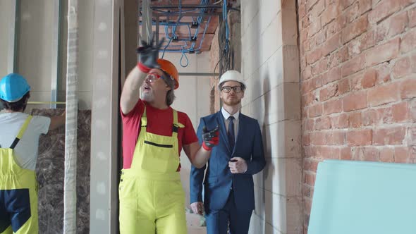 Foreman Builder and Construction Worker in Indoor Apartment