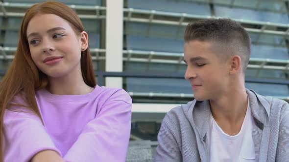 Shy Redhead Female Teen Looking at Male Classmate, Smiling Guy Feeling Sympathy