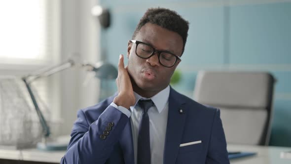 Portrait of African Businessman Having Neck Pain