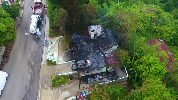 Aerial view around a burnt down house fire, in rural Mexico - circling, drone shot