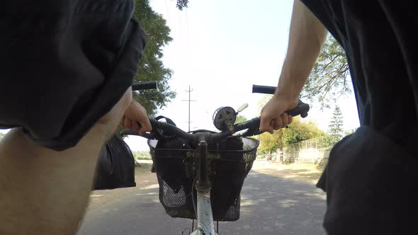 Lower angle road view during a bicycle ride in Mumbai.