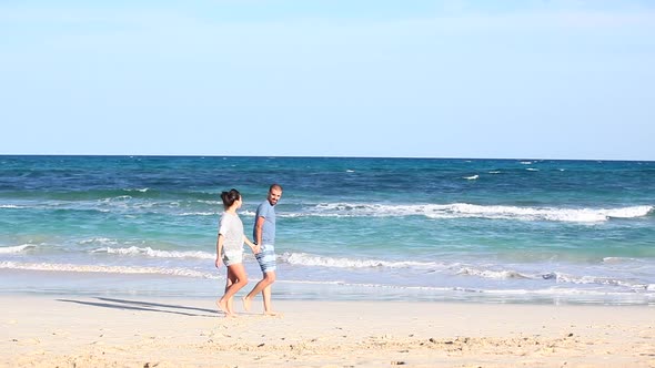Young couple in love spending time together at seaside in Fuerteventura, hugg