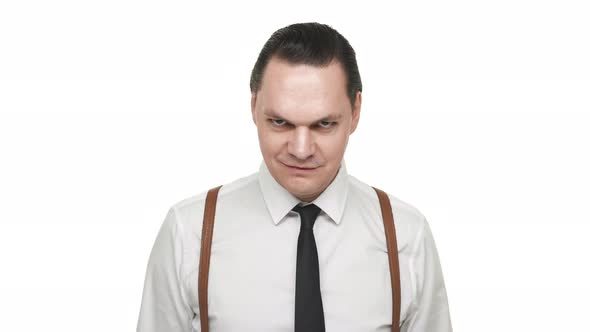 Portrait of Artistic Brunette Man Wearing Tie and Suspenders Grinning with Playful or Sarcastic