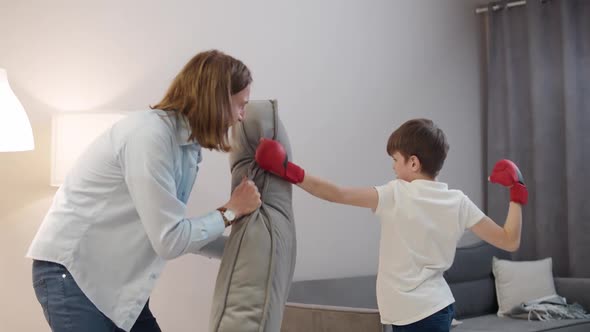 Entertainment at Selfisolation Father and Son Play Boxing a Boy in Red Gloves on His Hands Beats a