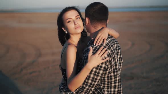 Close Up Slowmotion Video of Young Couple Hugs in a Sandy Plane