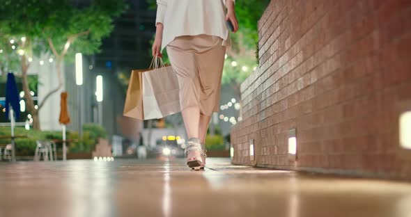 Woman in Evening Silk Dress on Fashionable Heels Walking with Shopping Bags, 