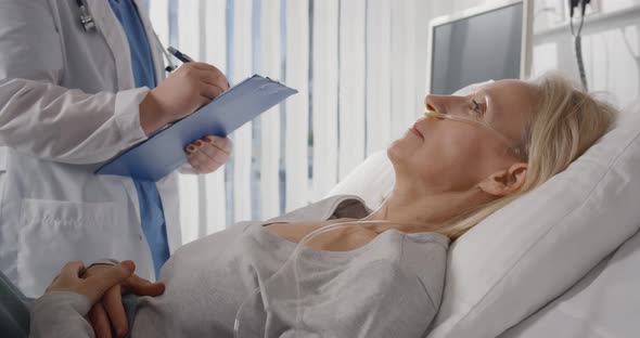 Doctor in Professional Uniform Examining Patient at Hospital or Medical Clinic