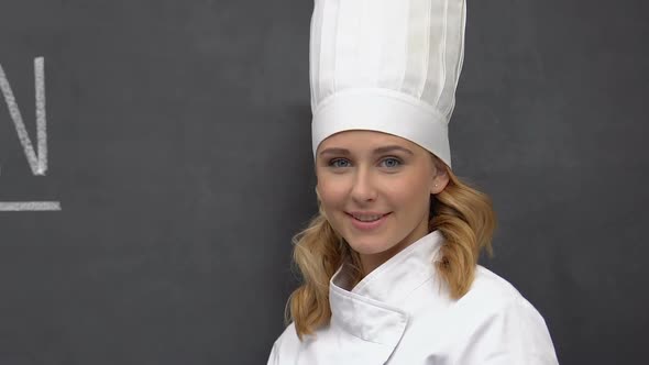 Vegan Written on Blackboard, Female Cook Smiling to Camera, Special Dieting Food