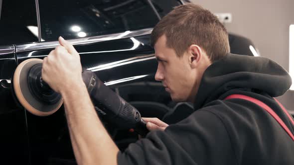 Process of Accurate Polishing of a Black New Car