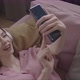 Girl Taking A Selfie While Lying On The Couch Top View - VideoHive Item for Sale