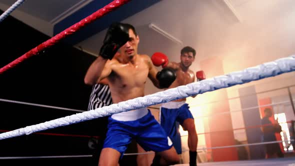 Two boxers fighting in boxing ring