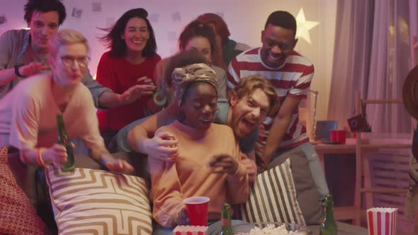 Group of Cheerful Multiethnic Friends Posing Together for Camera at Home Party