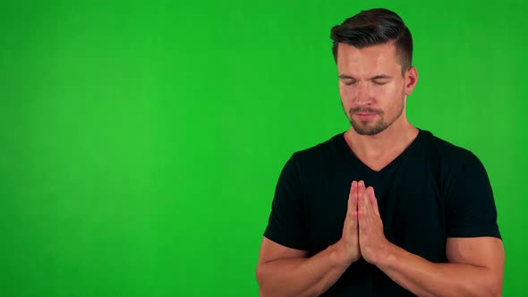 Young Handsome Caucasian Man Prays - Green Screen - Studio