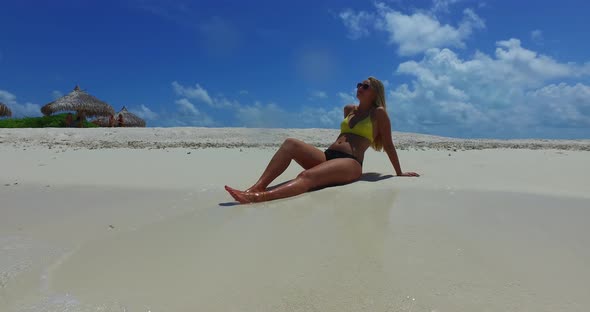 Modern beauty models on photoshoot having fun on the beach on summer white sandy and blue background