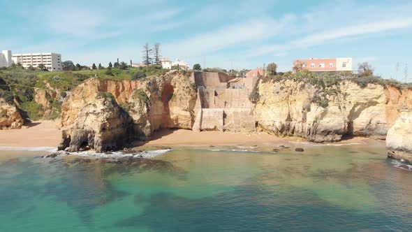 Pinhão Beach quiet cove with picturesque clear waters encircled by cliffs in Lagos, Algarve
