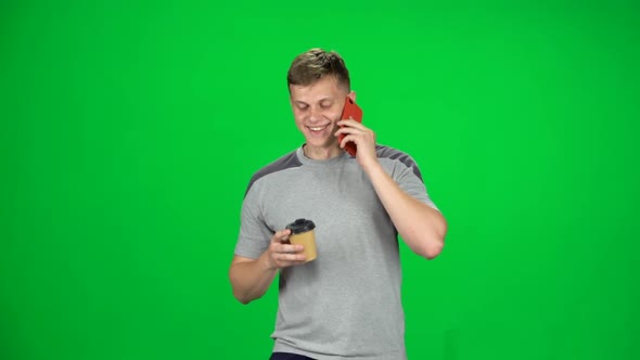 Young Man Walking Talking on the Phone and Drinking Coffee, Chroma Key, Slow Motion