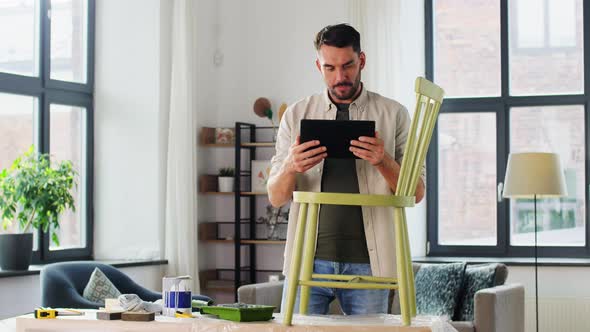 Man with Tablet Pc and Old Chair for Renovation