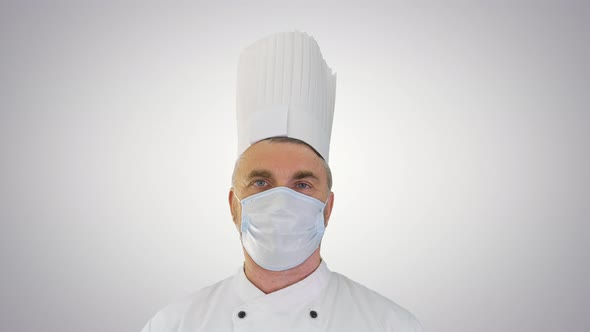 Male Chef Cook Wearing Face Protective Medical Mask for Protection From Virus Disease on Gradient