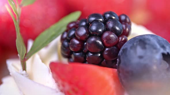 Macro Extreme Closeup Amazing Strawberry Blackberry and Blueberry Decorated with Sprig of Green