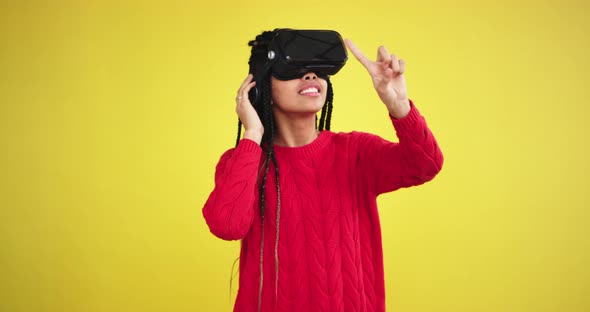 African Lady in a Red Tip Using a Virtual Reality