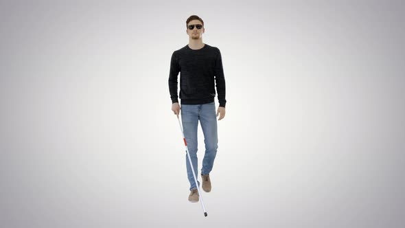 Blind Young Man with Stick Walking on Gradient Background.