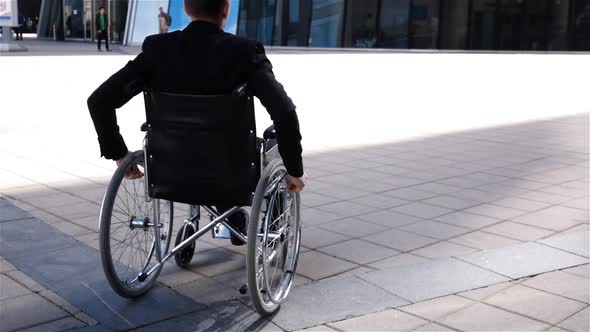 Disabled Entrepreneur in Wheelchair Move Near Modern Business Centre