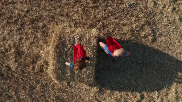 Top View of Dad with Son As Superheroes Outdoors