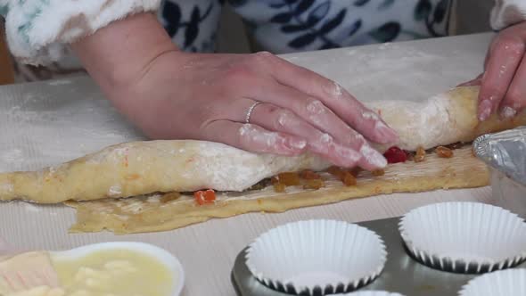 A Woman Rolls A Roll Of Rolled Dough. Prepares Cruffin With Raisins And Candied Fruit.