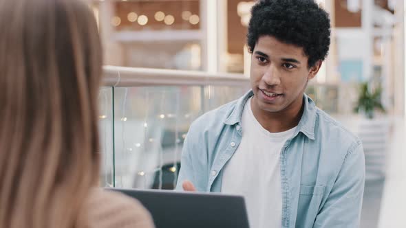 African Businessman and Unrecognizable Caucasian Businesswoman Talking Negotiating at Office