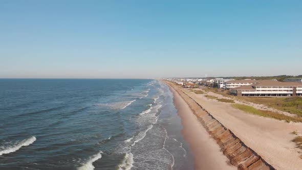 Rising drone shot of resorts and hotels on the beach in Oak Island NC