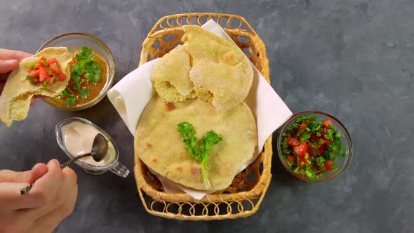 Homemade corn flatbread female hands cilantro green tomato salsa Handmade mexican tortilla vegetable