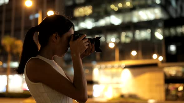 Female Photographer taking photo in the city