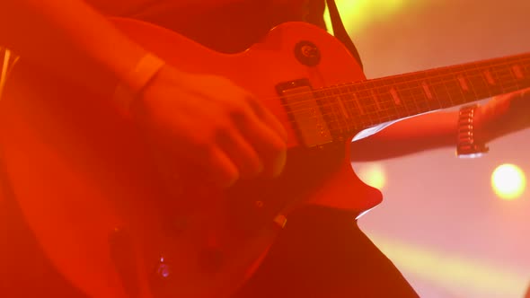 Lead Guitarist Performs on the Stage with a Rock Band