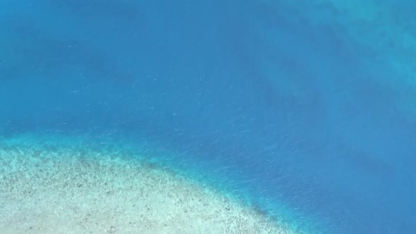 Aerial drone tourism of seashore beach break by blue sea with sand background