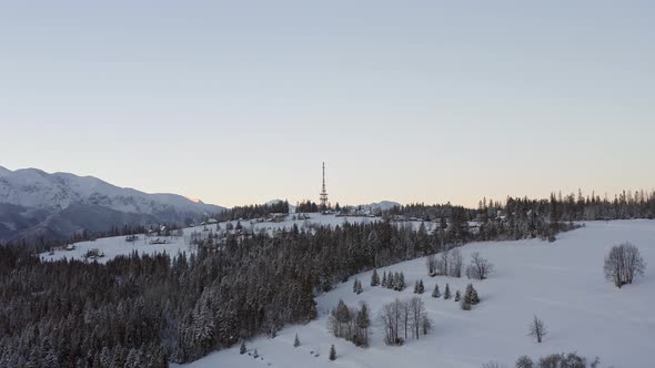 Zakopane-Gubalowka Transmitter Tower With Dense Forest And Snowy Gubalowka Mountain At Zakopane, Pol