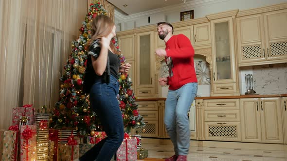Couple Dance Near Christmas Tree in the Kitchen