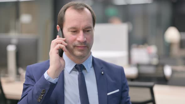 Portrait of Businessman Talking on Smartphone