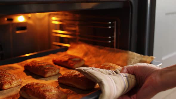 Woman Cooking Food in Oven at Home Kitchen