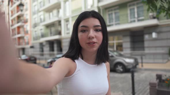 Selfie Camera POV of Confident Beautiful Teenage Girl with Nose Piercing Talking Smiling Standing on