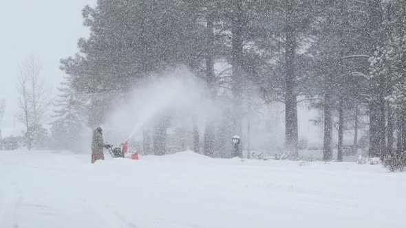 Man Using Snowblower in a Blizzard Wide