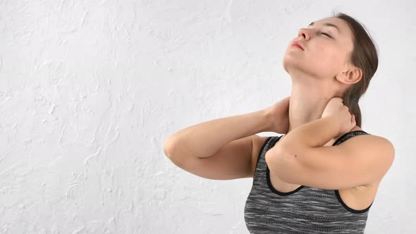 Relaxed Sports Female Turning Head Stretching Neck Isolated at White Studio Background