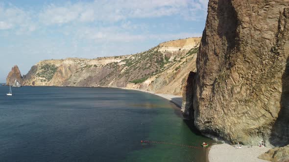 Aerial View From Above on Calm Azure Sea and Volcanic Rocky Shores