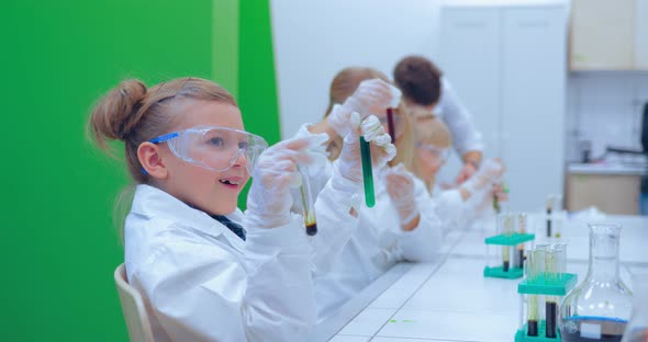 Group of Kids Making Experiments in Chemistry Class