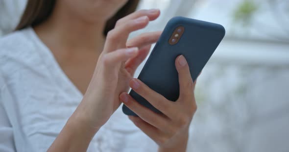 Woman look at mobile phone at street