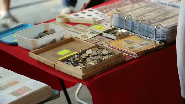 Wooden Box with Many Ancient Coins on Table, Male Tourist Choosing Souvenir